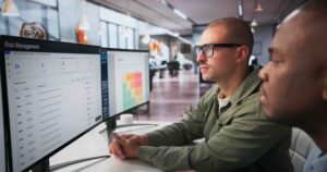 Man at computer reading reports